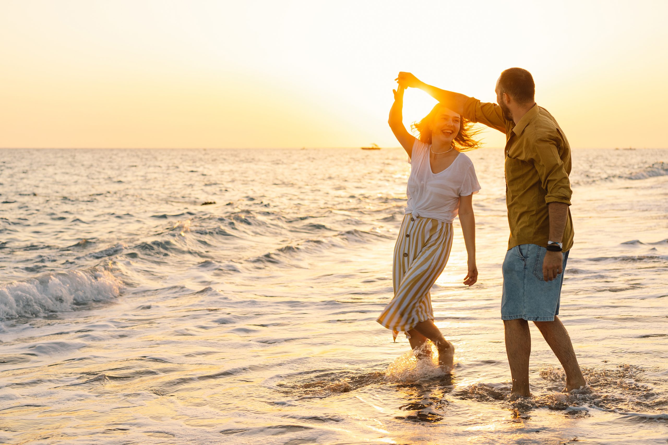 Young Romantic Couple Dancing Turning Around By Sea. Seascape At